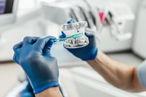 dentistry-models-human-teeth-manufacture-dental-prostheses-installation-implants-with-toothbrush_496169-954